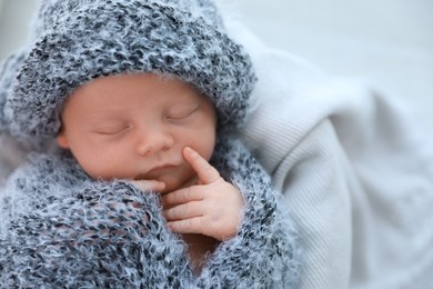 Photo of Cute newborn baby sleeping on plaid, top view