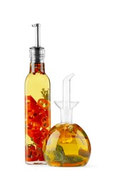 Photo of Different sorts of cooking oil with spices and herbs in bottles on white background