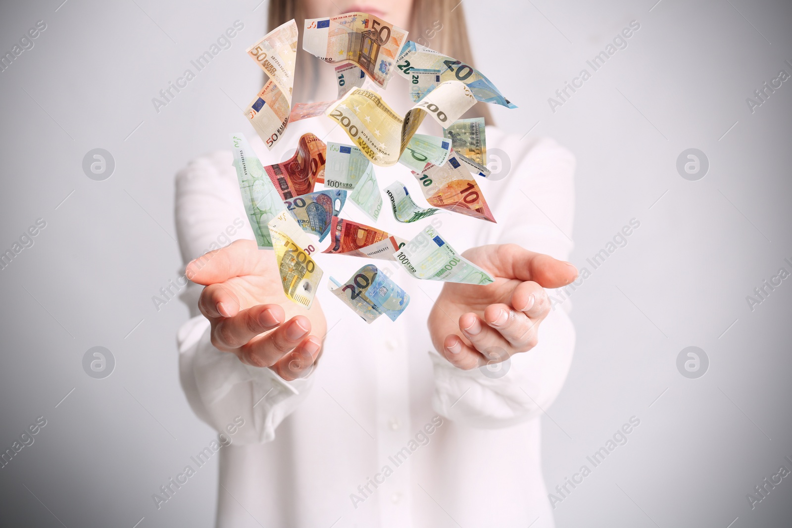 Image of Woman with money on light grey background, closeup. Currency exchange