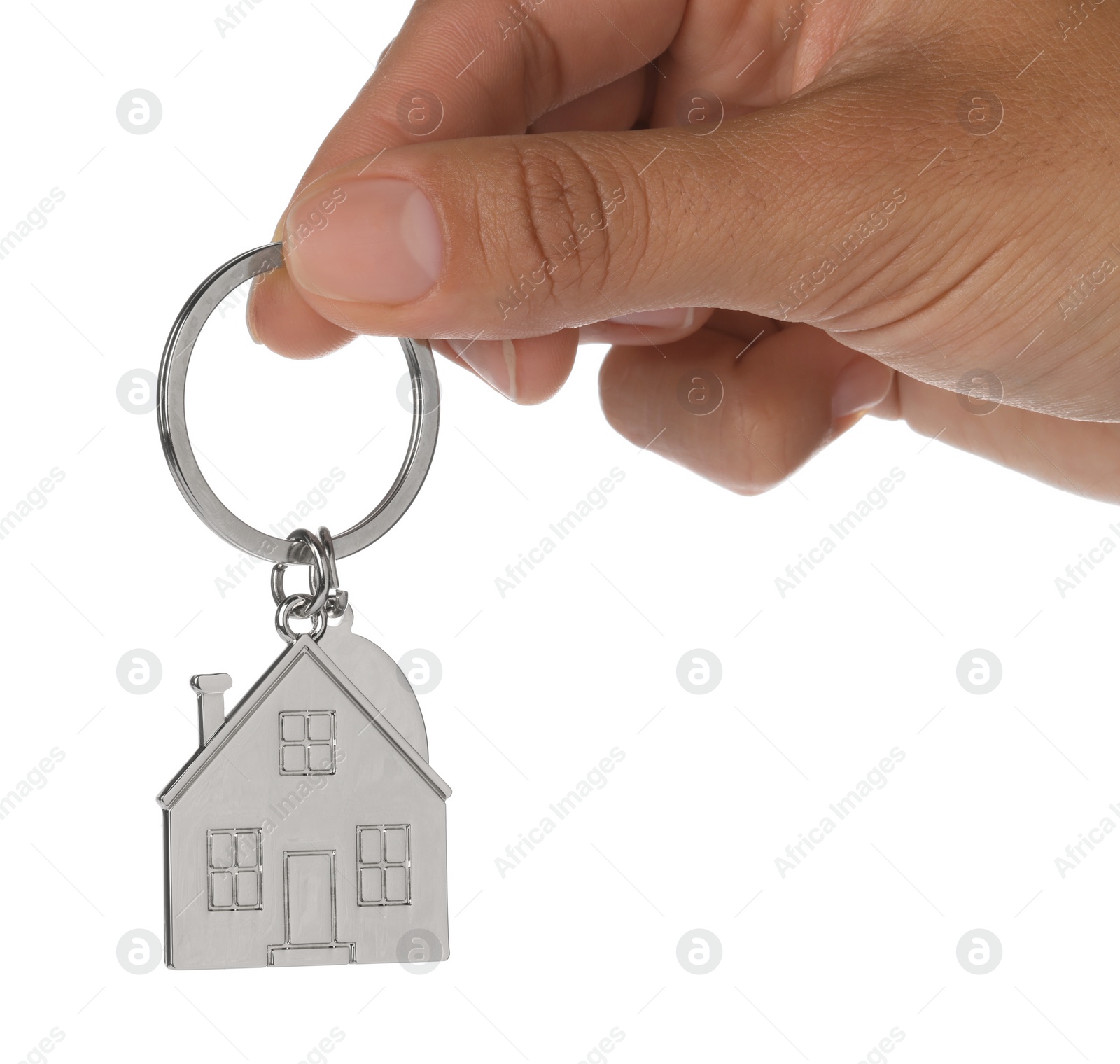 Photo of Woman holding metallic keychain in shape of house on white background, closeup