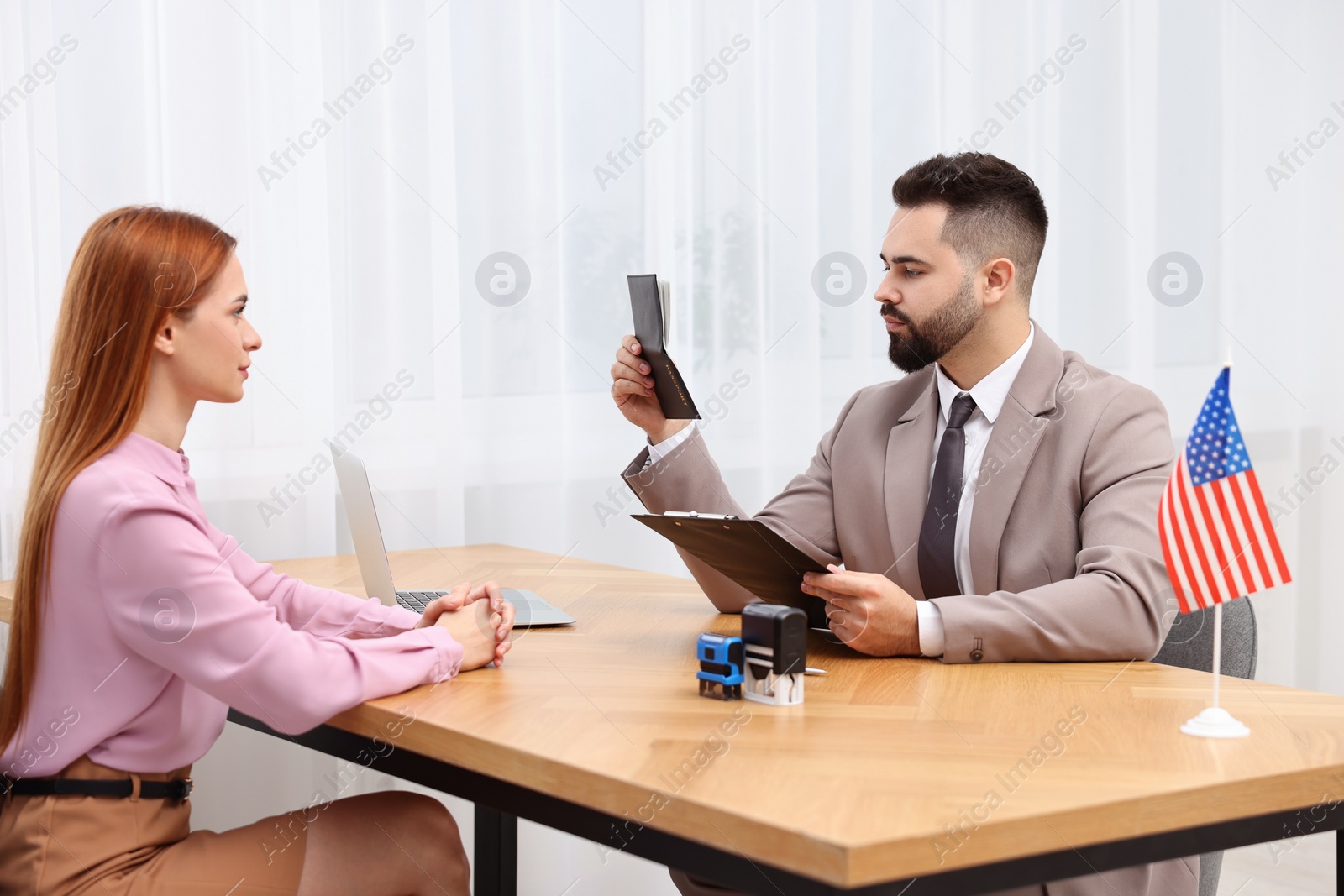 Photo of Immigration to United States. Woman having interview with embassy worker in office