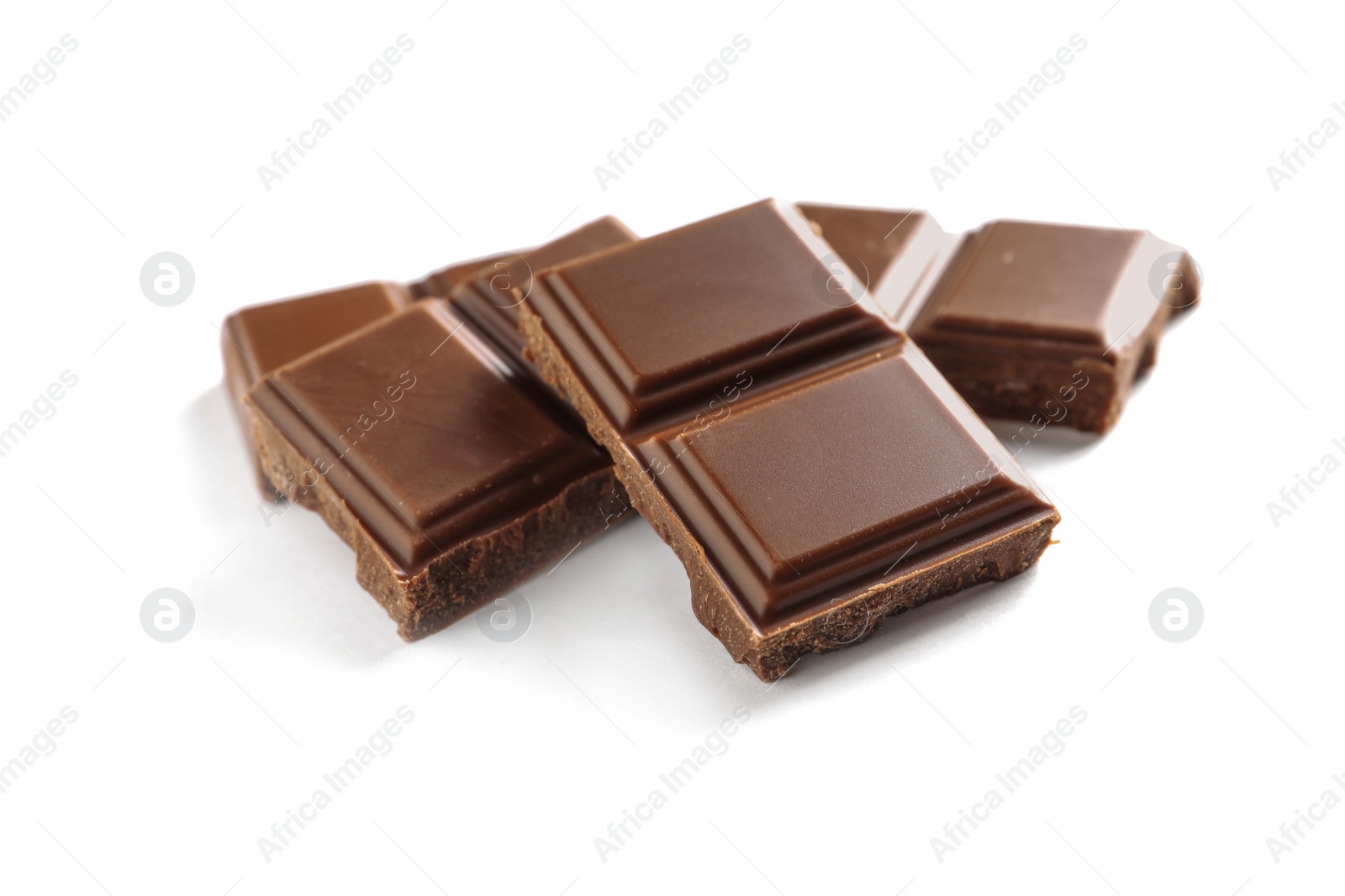 Photo of Pieces of tasty milk chocolate on white background