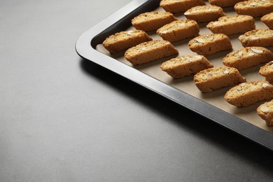 Photo of Traditional Italian almond biscuits (Cantucci) on grey table. Space for text