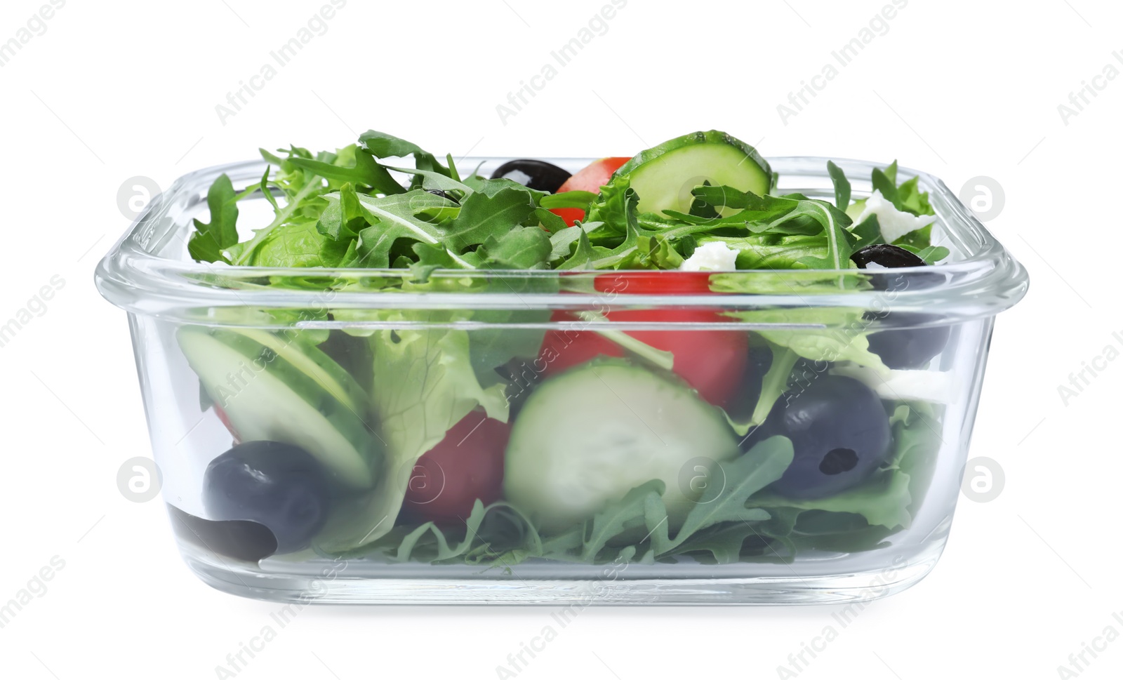 Photo of Tasty vegetable salad with cheese and olives in glass container isolated on white