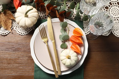 Beautiful autumn table setting. Plates, cutlery, glasses and floral decor, flat lay