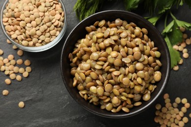 Photo of Delicious lentils in bowls on grey table, flat lay