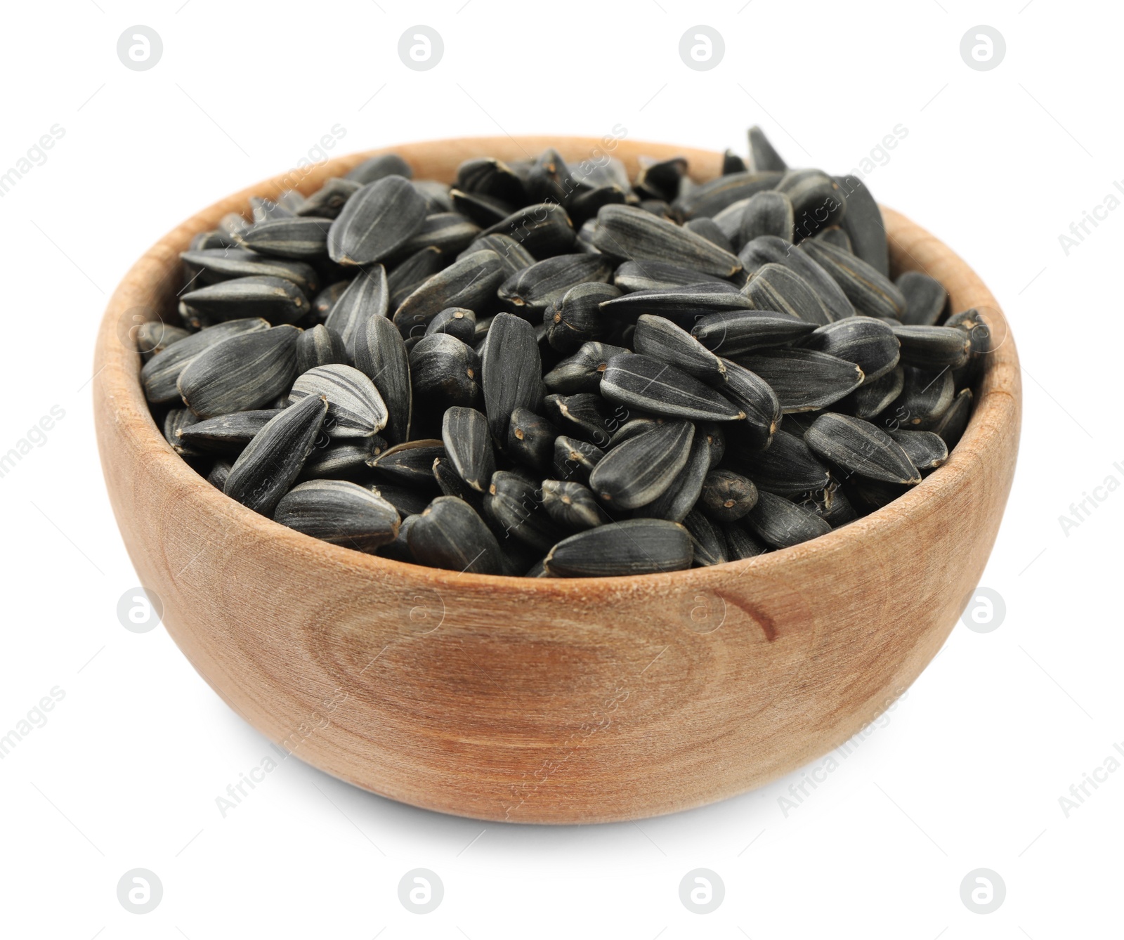 Photo of Raw organic sunflower seeds in wooden bowl isolated on white
