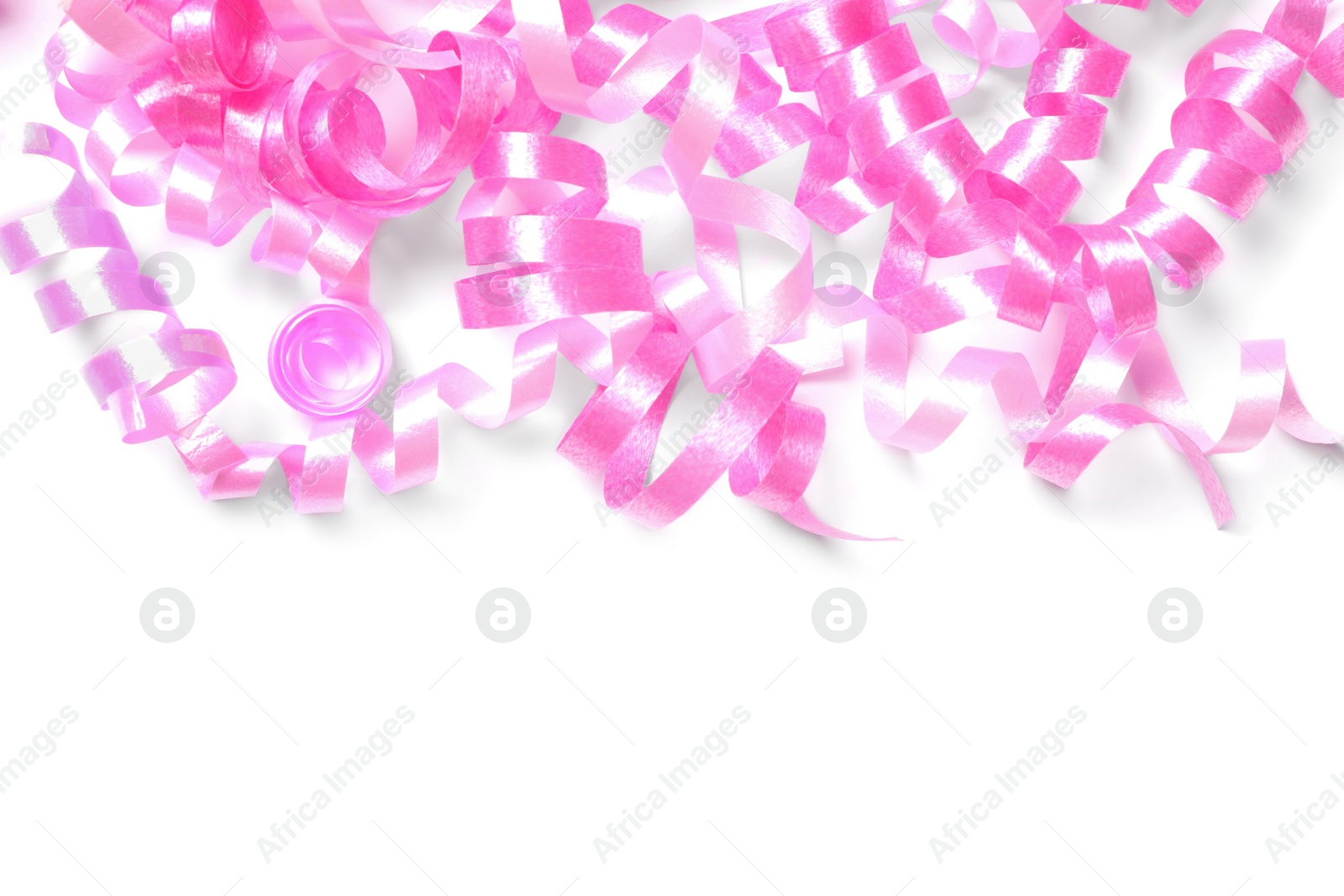 Photo of Pink serpentine streamers on white background, top view