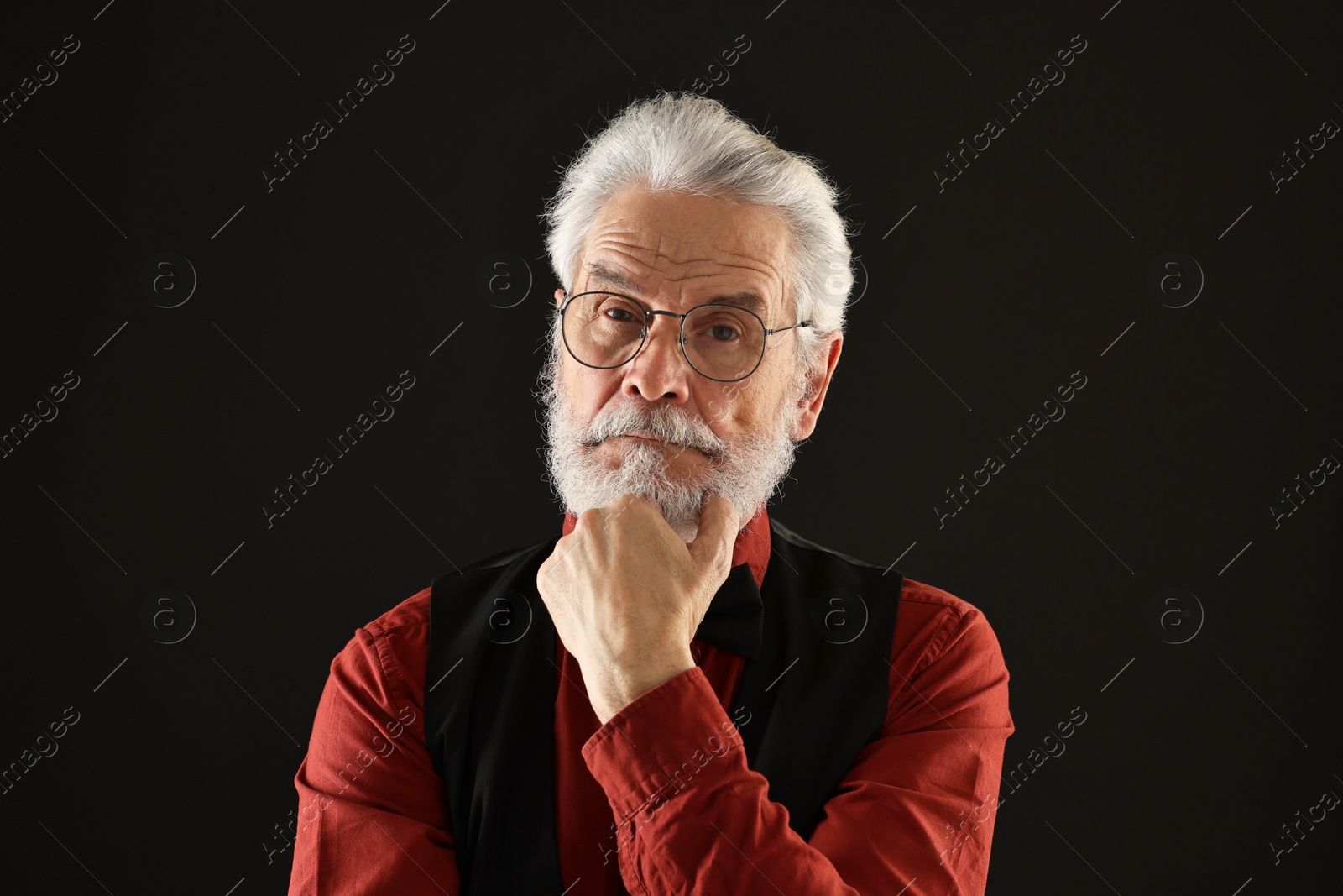 Photo of Senior man with mustache on black background