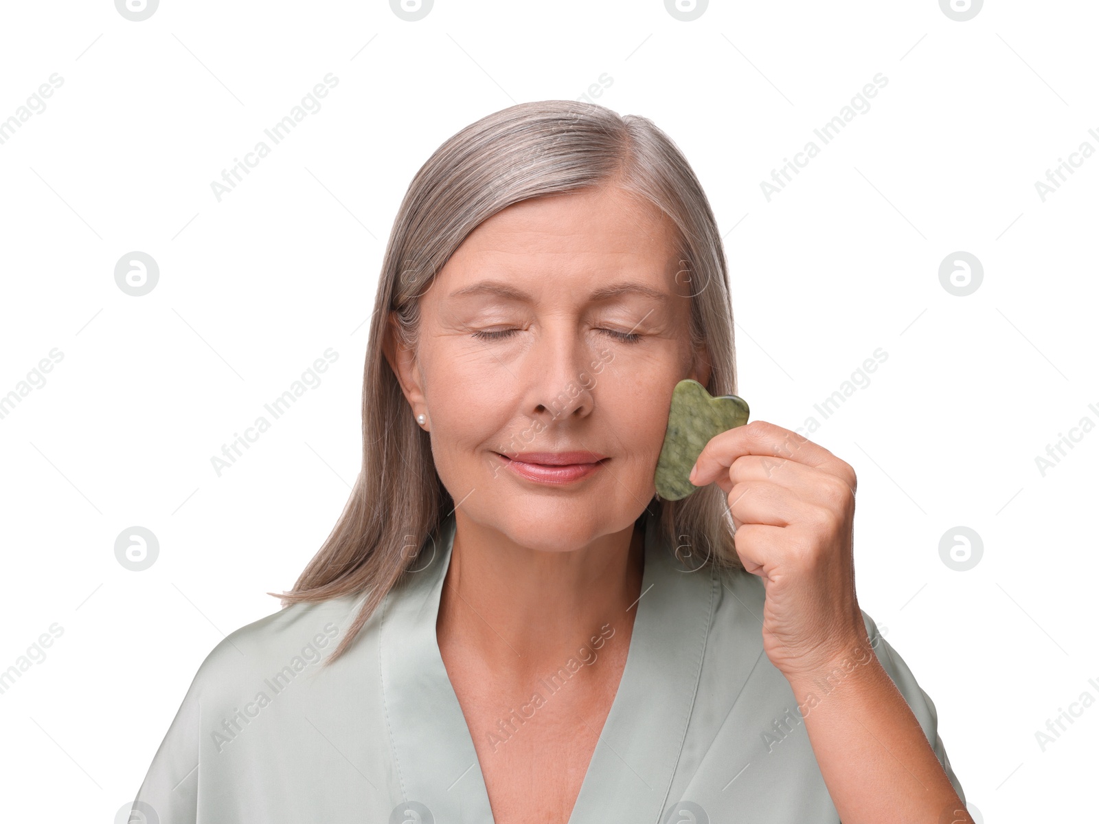 Photo of Woman massaging her face with jade gua sha tool isolated on white