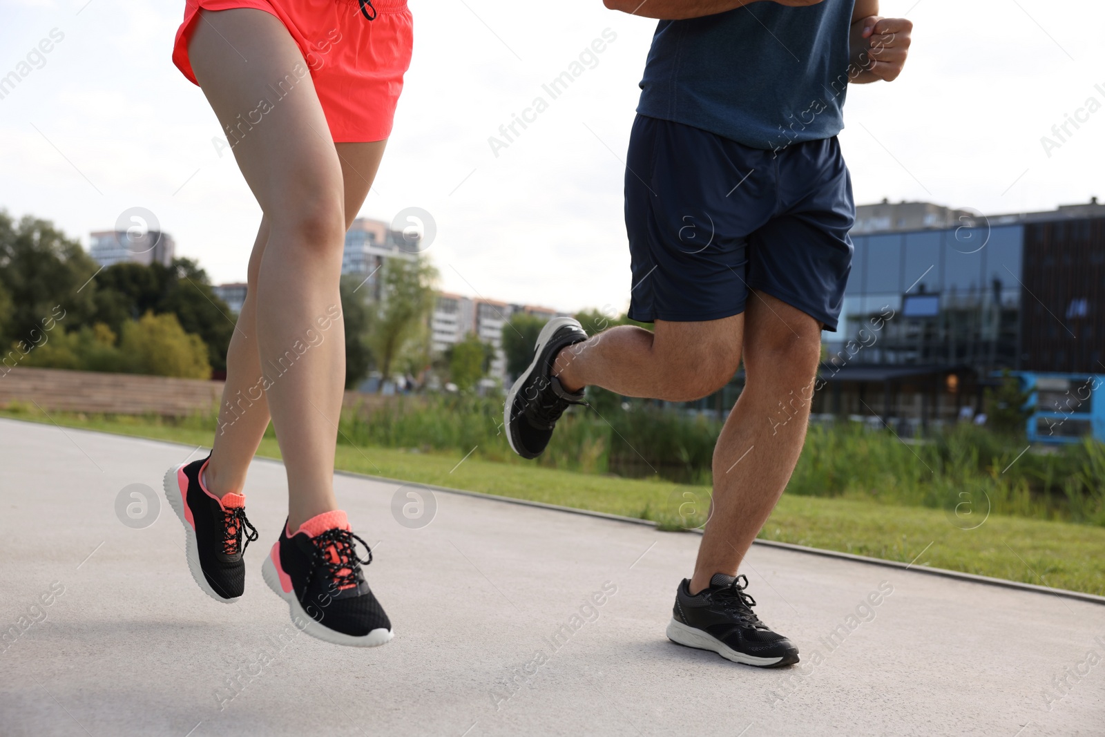 Photo of Healthy lifestyle. Couple running outdoors, closeup view