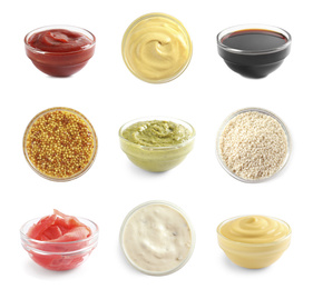 Set of different delicious sauces and condiments on white background