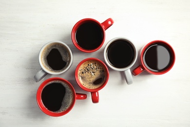 Flat lay composition with cups of coffee on light background. Food photography