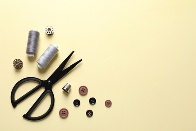 Photo of Flat lay composition with scissors on color background. Space for text