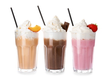 Photo of Glasses with delicious milk shakes on white background