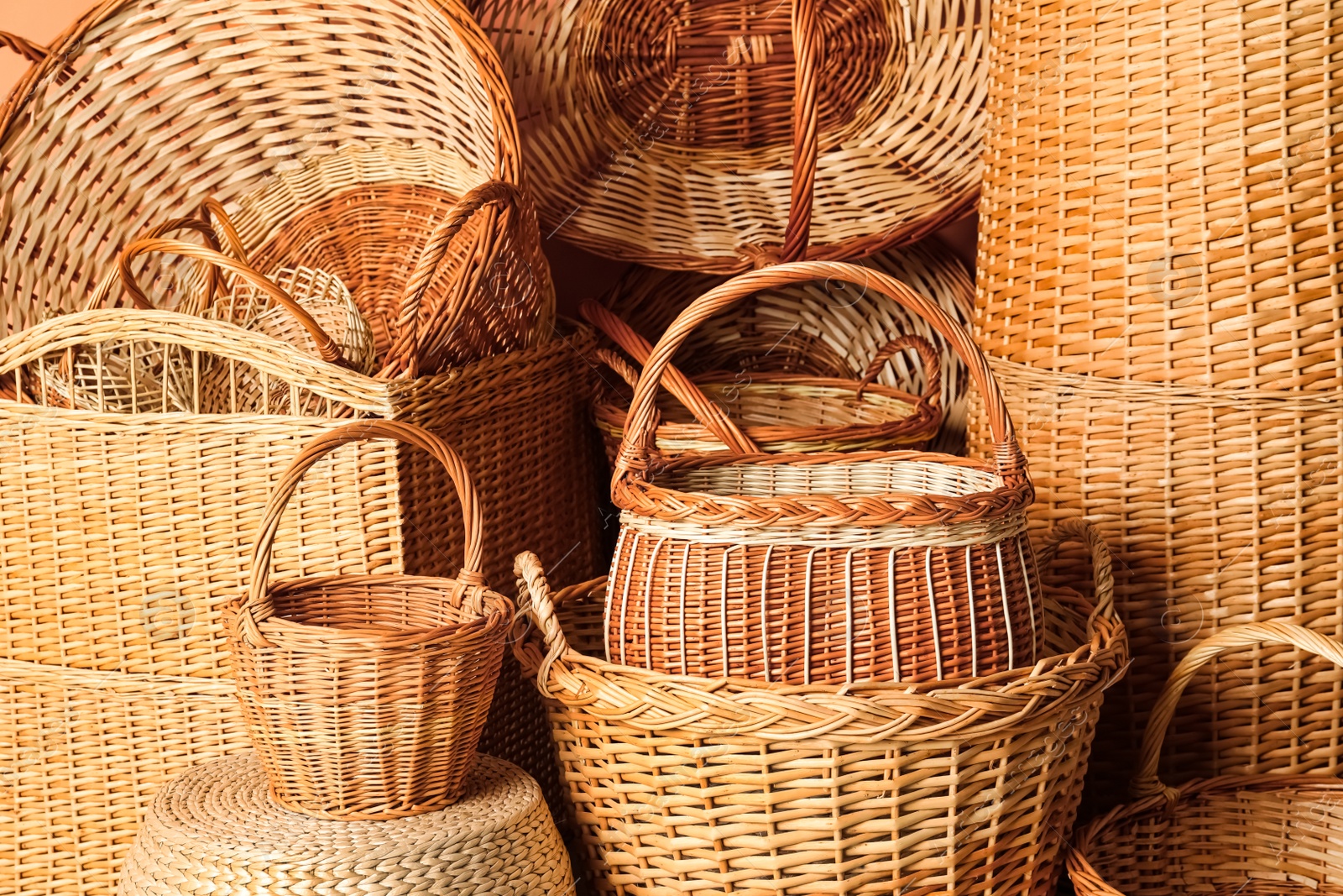 Photo of Many different wicker baskets made of natural material as background