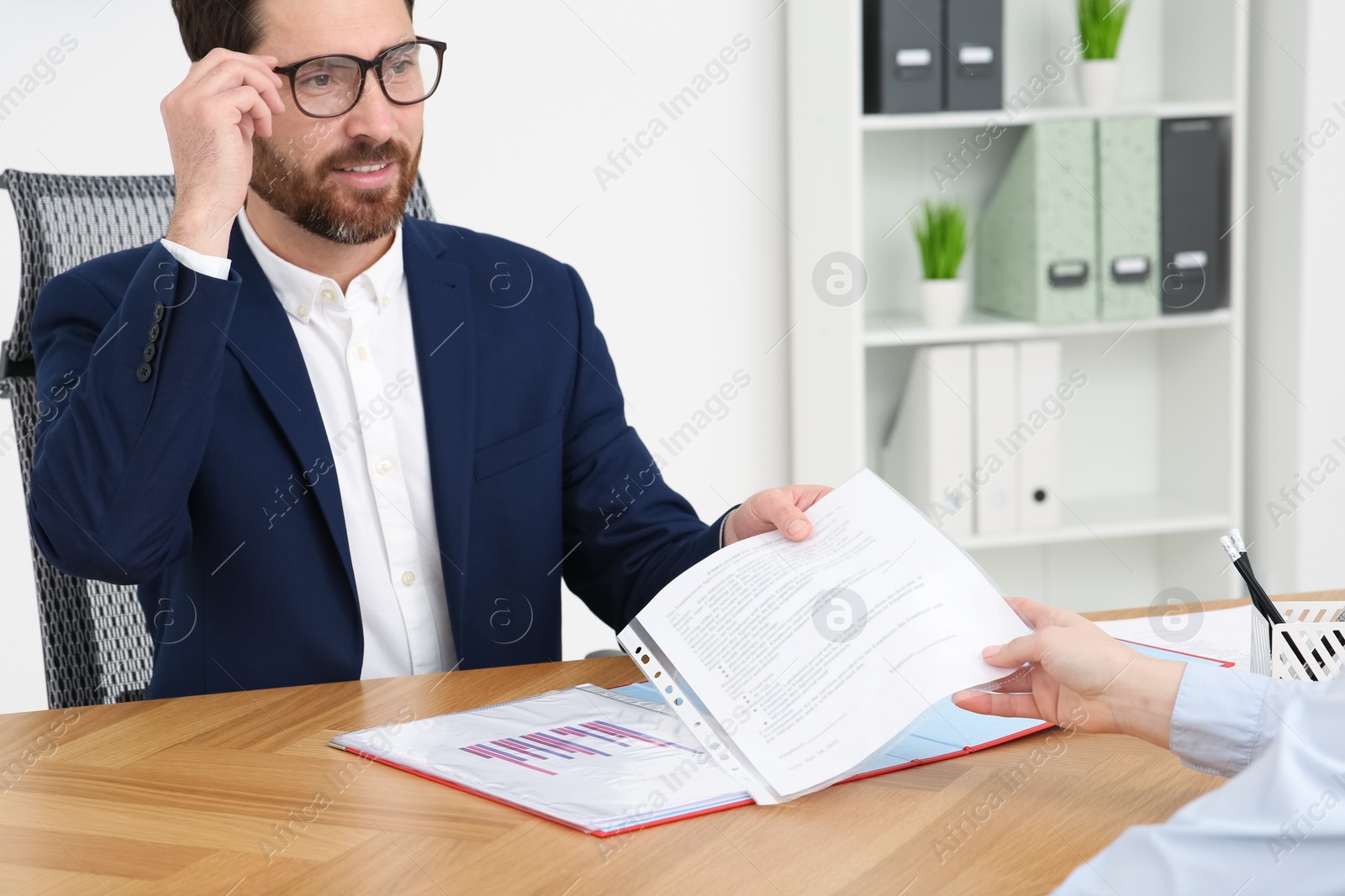 Photo of Businesspeople working with documents at table in office