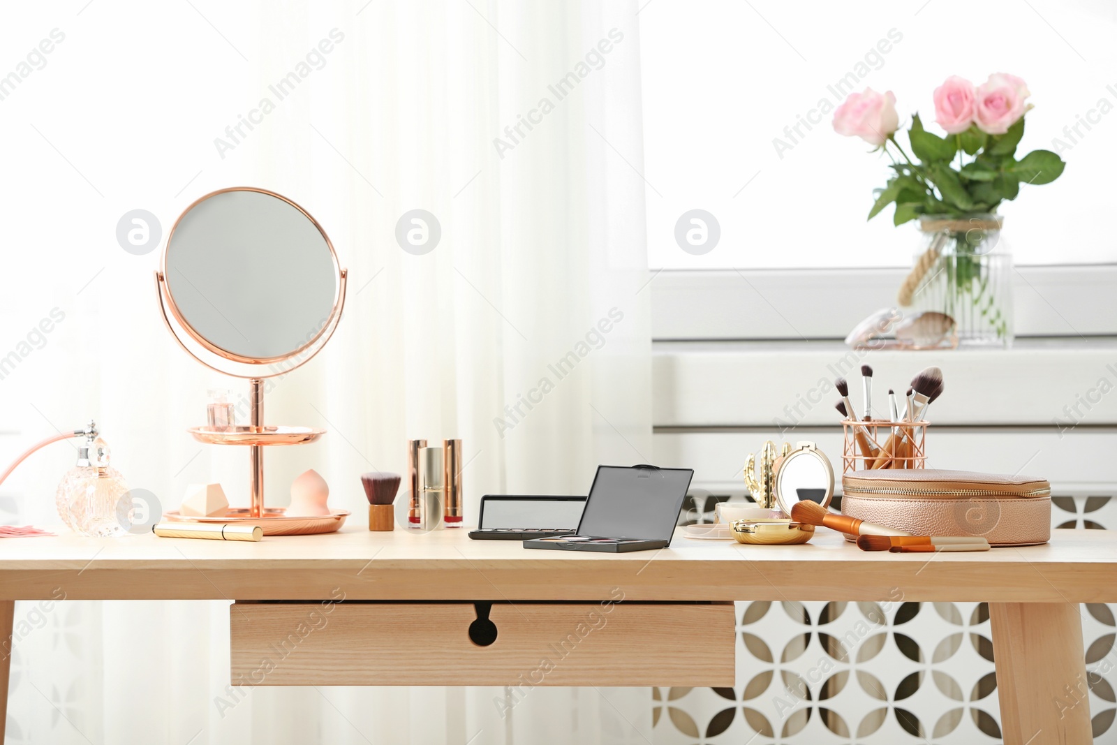 Photo of Dressing table with different makeup products and accessories in room interior