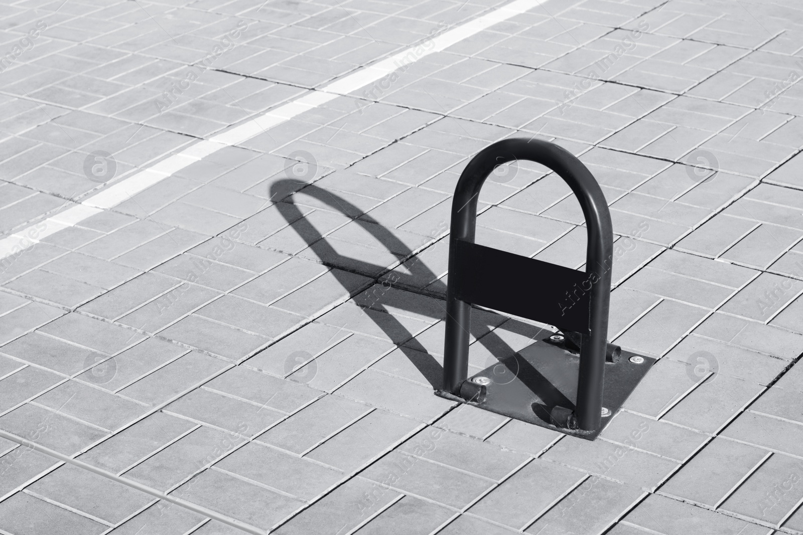 Photo of Parking barrier with No Stopping road sign on pavement outdoors, space for text