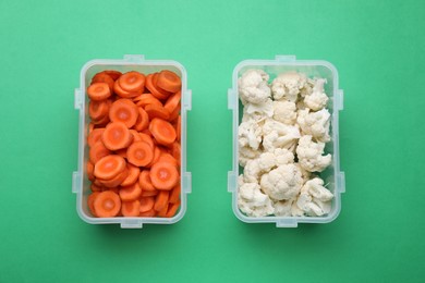 Plastic containers with fresh products on green background, flat lay