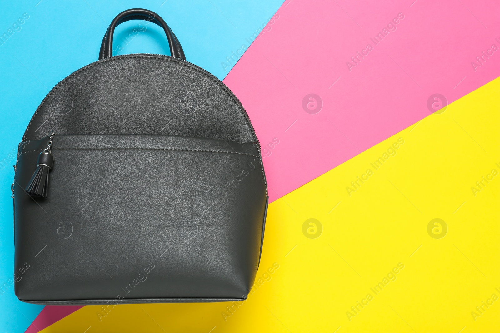 Photo of Stylish urban backpack on color background, top view. Space for text