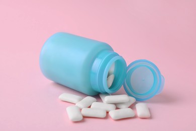 Photo of Jar with chewing gums on pink background, closeup