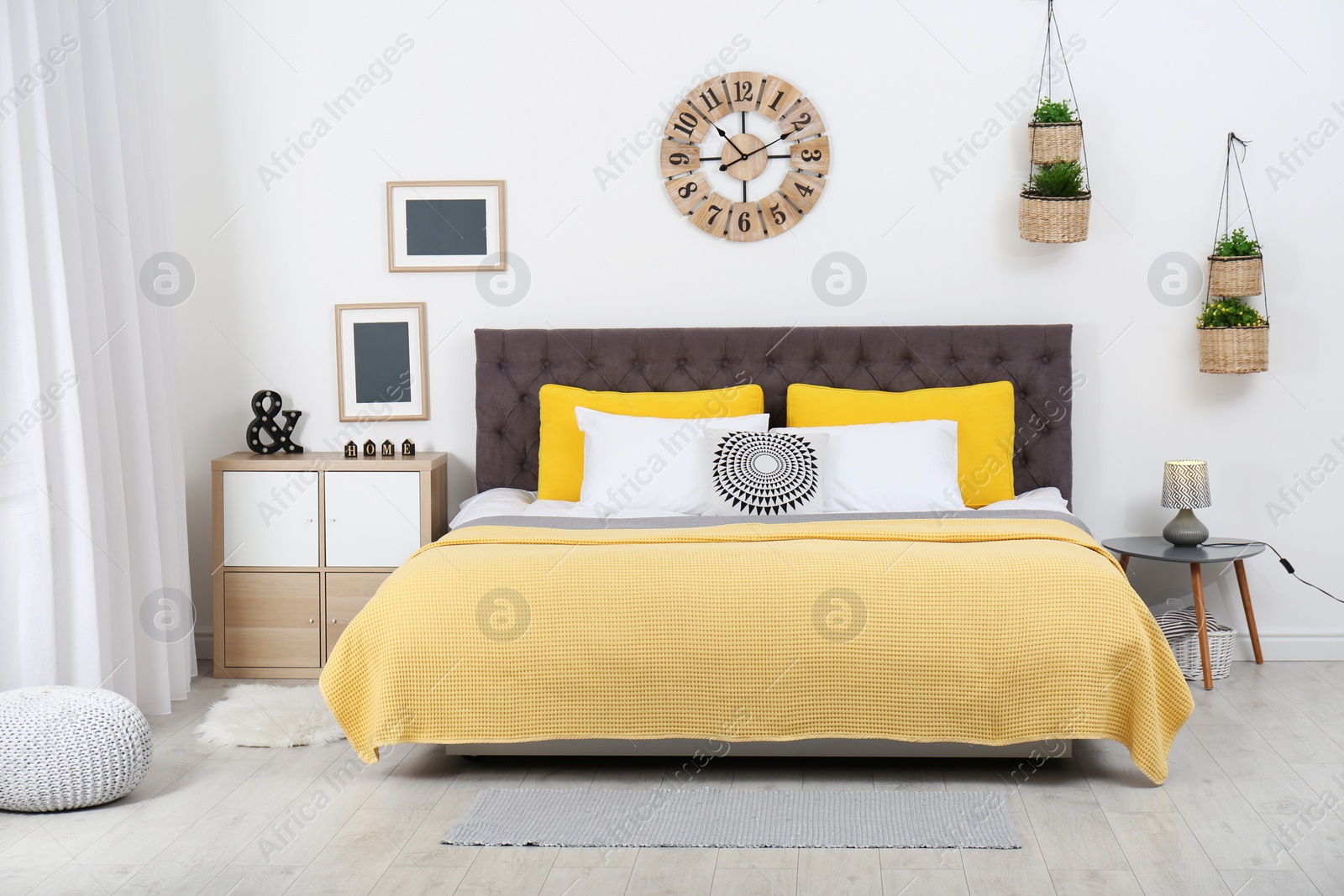 Photo of Stylish room interior with large comfortable bed