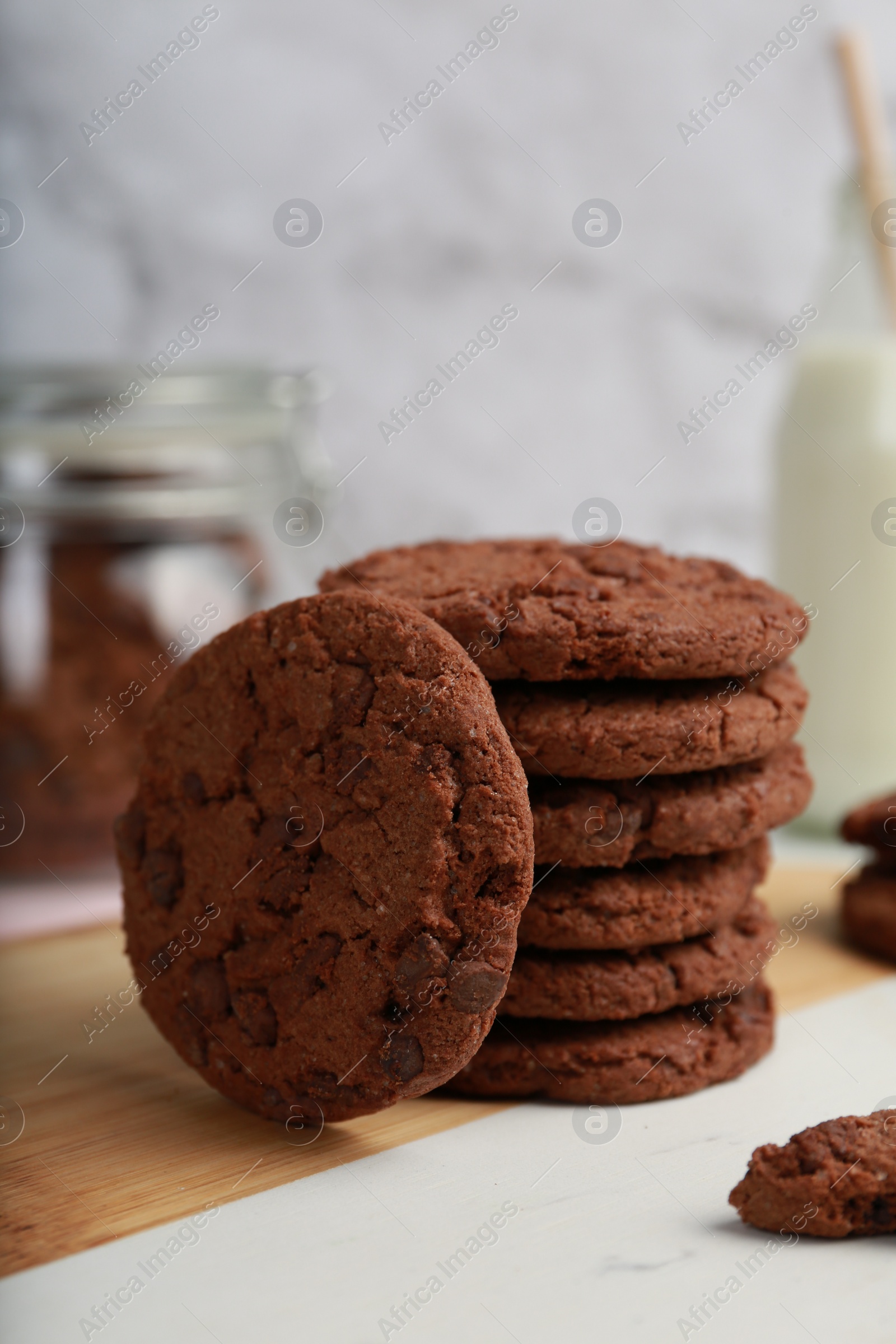 Photo of Tasty chocolate cookies on wooden board, closeup