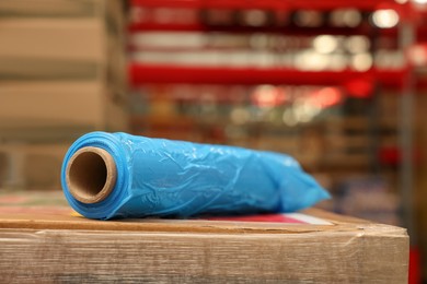 Photo of Roll of stretch wrap on box in warehouse