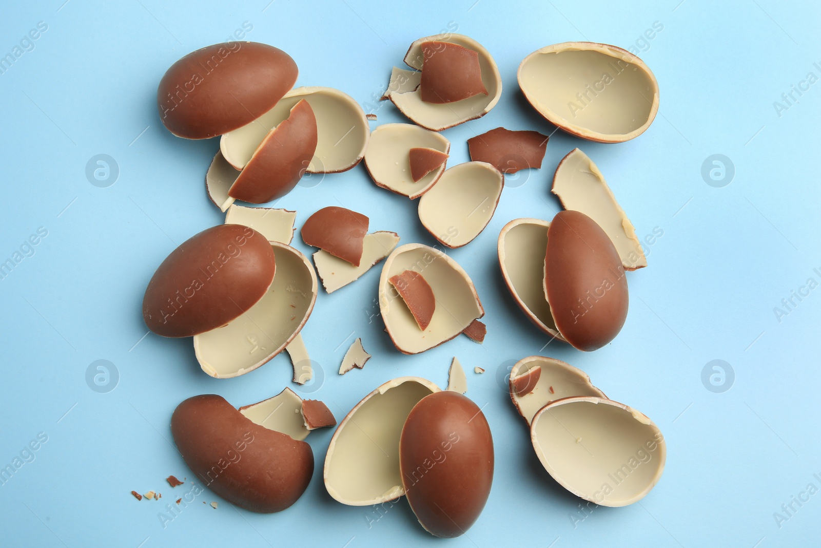 Photo of Sveti Vlas, Bulgaria - July 3, 2023: Broken halves of Kinder Surprise Eggs on light blue background, flat lay