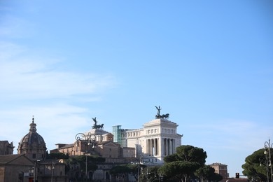 Rome, Italy - February 4, 2024 : Santi Luca e Martina church and Victor Emmanuel II monument outdoors