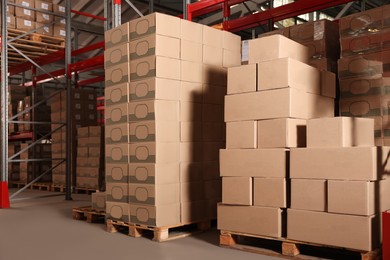 Warehouse with stacks of boxes on wooden pallets. Wholesaling