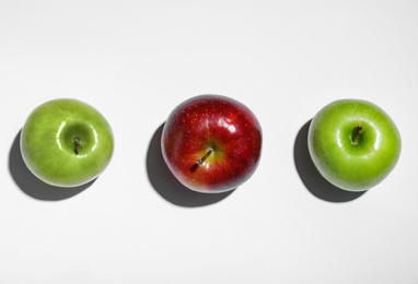 Ripe red and green apples on white background, top view