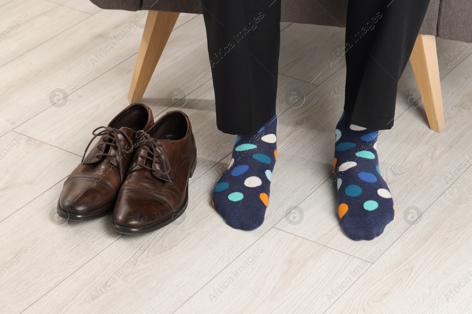 Photo of Man wearing colorful socks indoors, closeup view