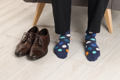 Man wearing colorful socks indoors, closeup view