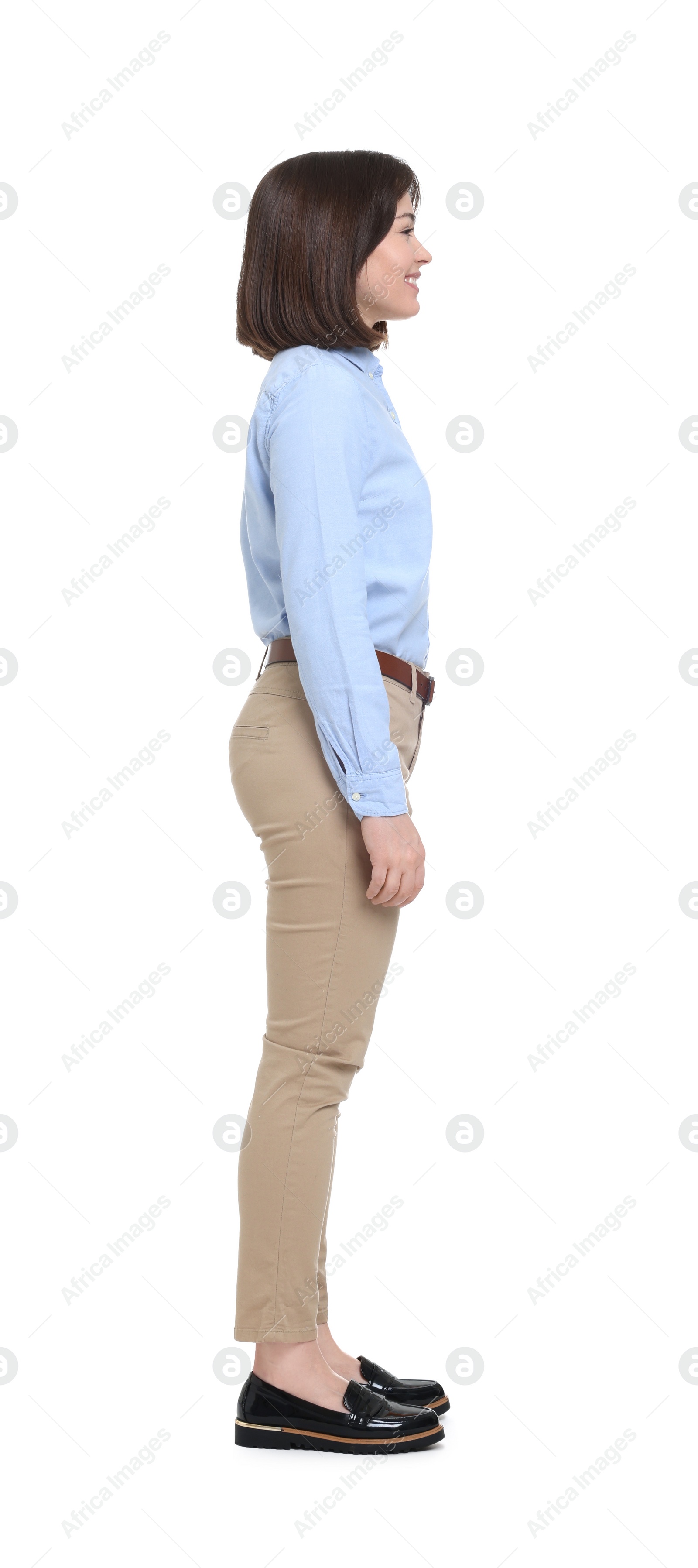 Photo of Happy businesswoman in blue shirt and beige pants on white background