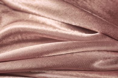 Photo of Texture of rose gold silk as background, closeup