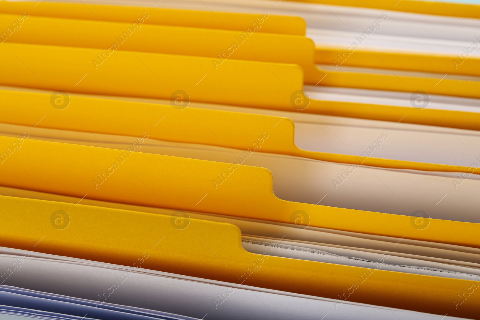 Photo of Many yellow files with documents as background, closeup