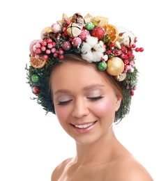 Beautiful young woman wearing Christmas wreath on white background