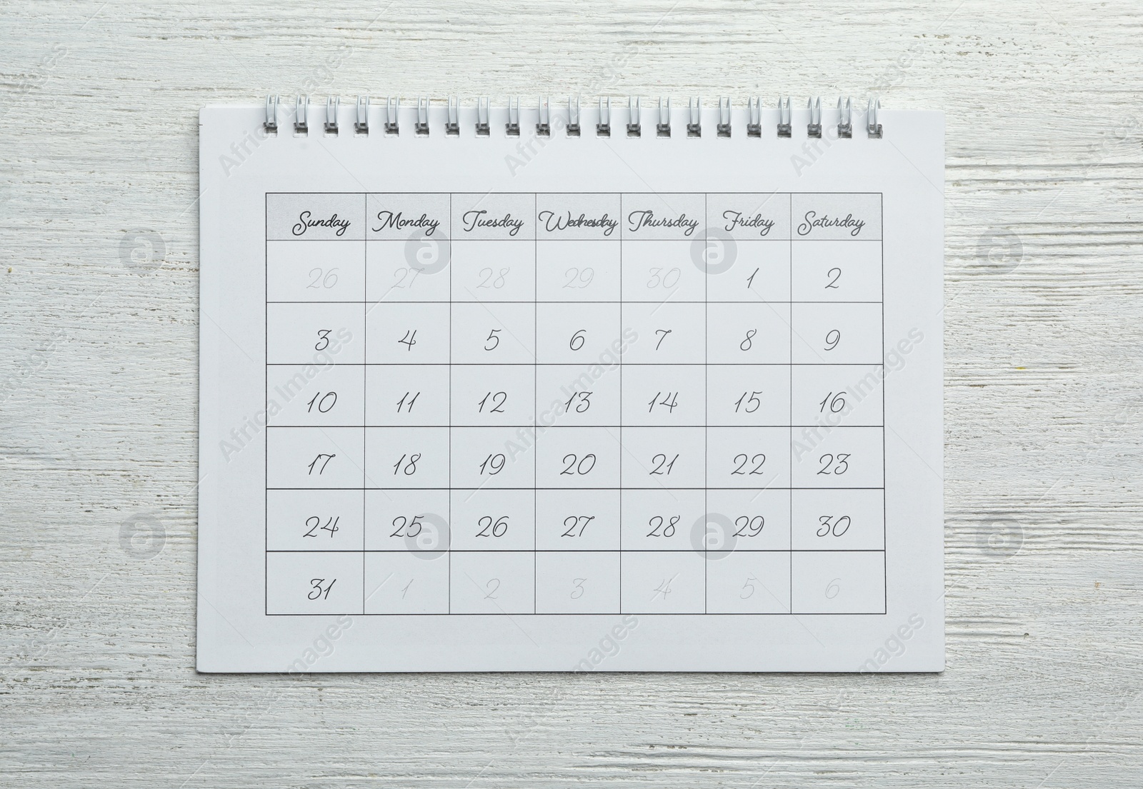 Photo of Paper calendar on white wooden background, top view