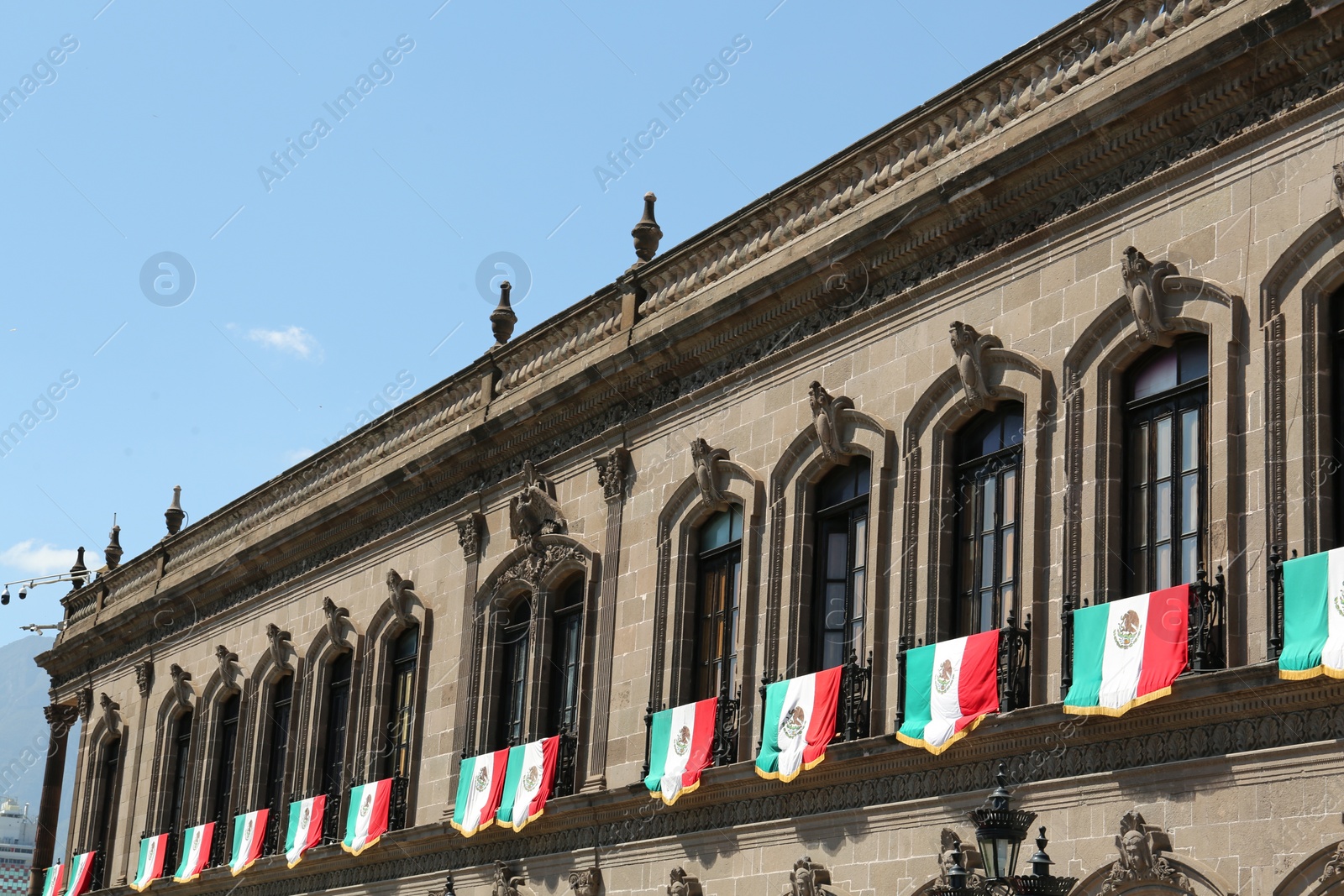 Photo of MONTERREY (NUEVO LEON), MEXICO - SEPTEMBER 29, 2022: Beautiful view of Palacio de Gobierno (Government Palace) with flags on sunny day