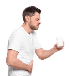 Photo of Man with glass of milk suffering from lactose intolerance on white background