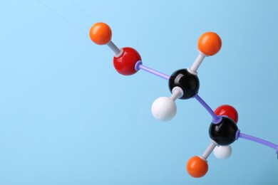 Photo of Molecule of sugar on light blue background, closeup and space for text. Chemical model