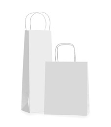 Photo of Blank paper bags on white background. Mockup for design