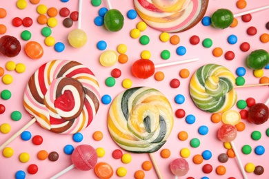 Photo of Flat lay composition with delicious colorful candies on color background