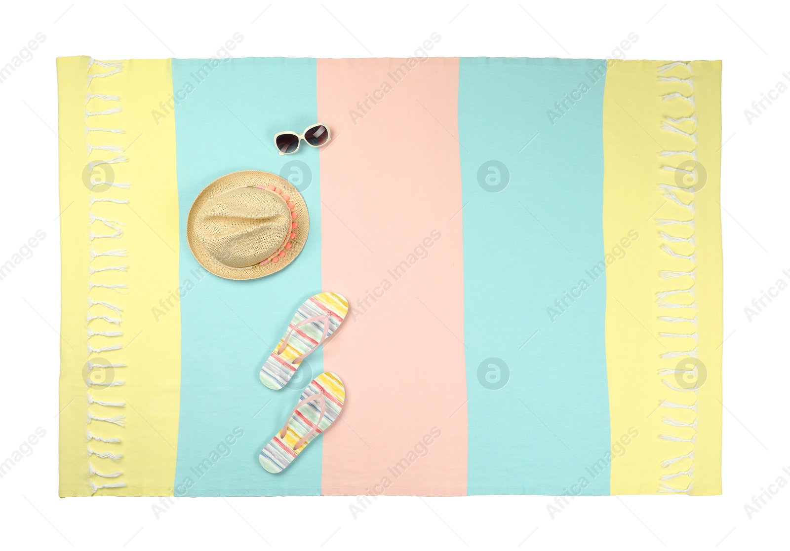 Photo of Colorful beach towel with flip flops, hat and sunglasses on white background, top view