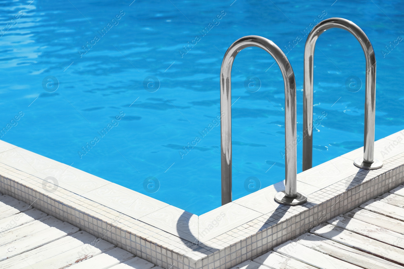 Photo of Modern swimming pool with step ladder outdoors