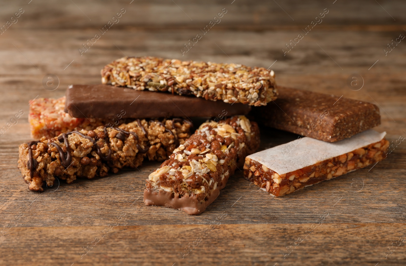 Photo of Tasty protein bars on wooden table. Healthy snack