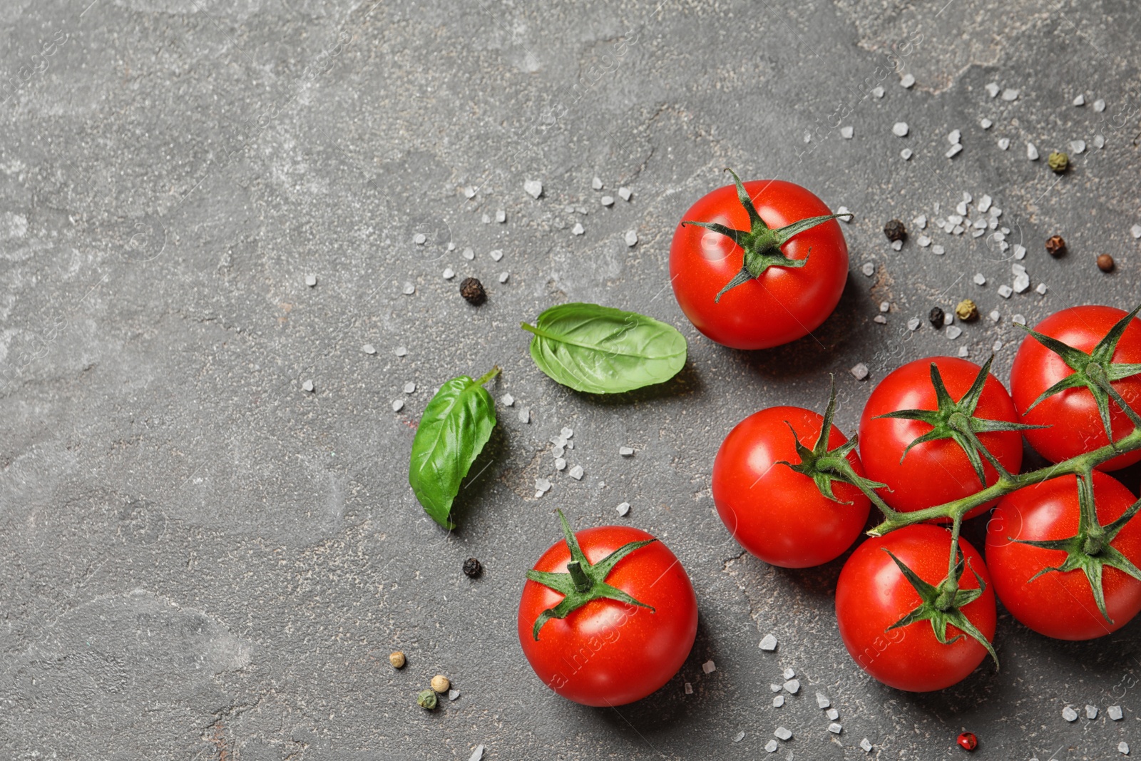 Photo of Flat lay composition with cherry tomatoes on stone background. Space for text