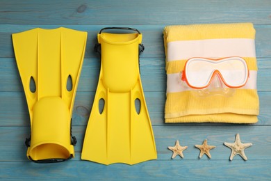 Flat lay composition with beach objects on light blue wooden background